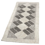 Vaip „Cream Diamond Mosaic Rug“, 70x140 cm. Kreemikarva vaip tumedamate hallide elementide ja peente kolmnurkadega nurkades. Vaip „Cream Diamond Mosaic Rug“, 70x140 cm. Kreemikarva vaip tumedamate hallide elementide ja peente kolmnurkadega nurkades.